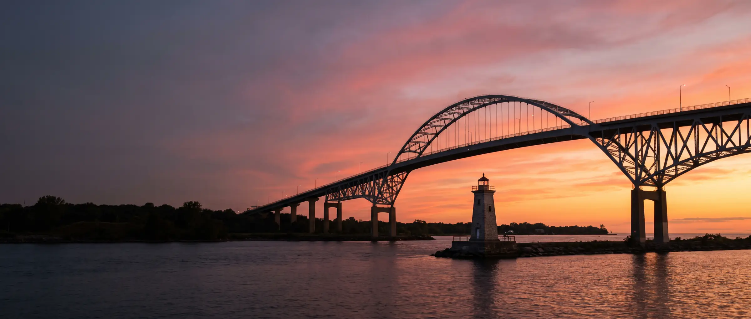 Christian-Owned Businesses in Burlington, ON: the Skyway bridge and the pier lighthouse on Lake Ontario