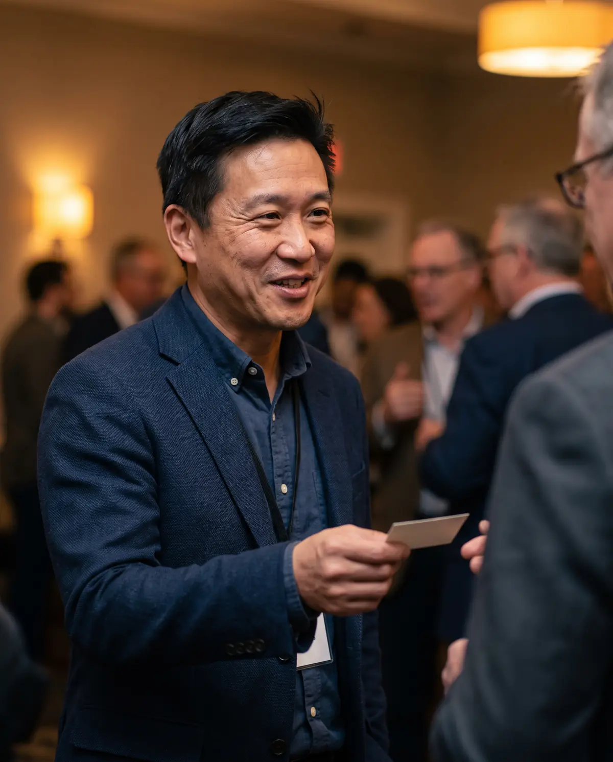 Small business owner handing over his business card at a networking event