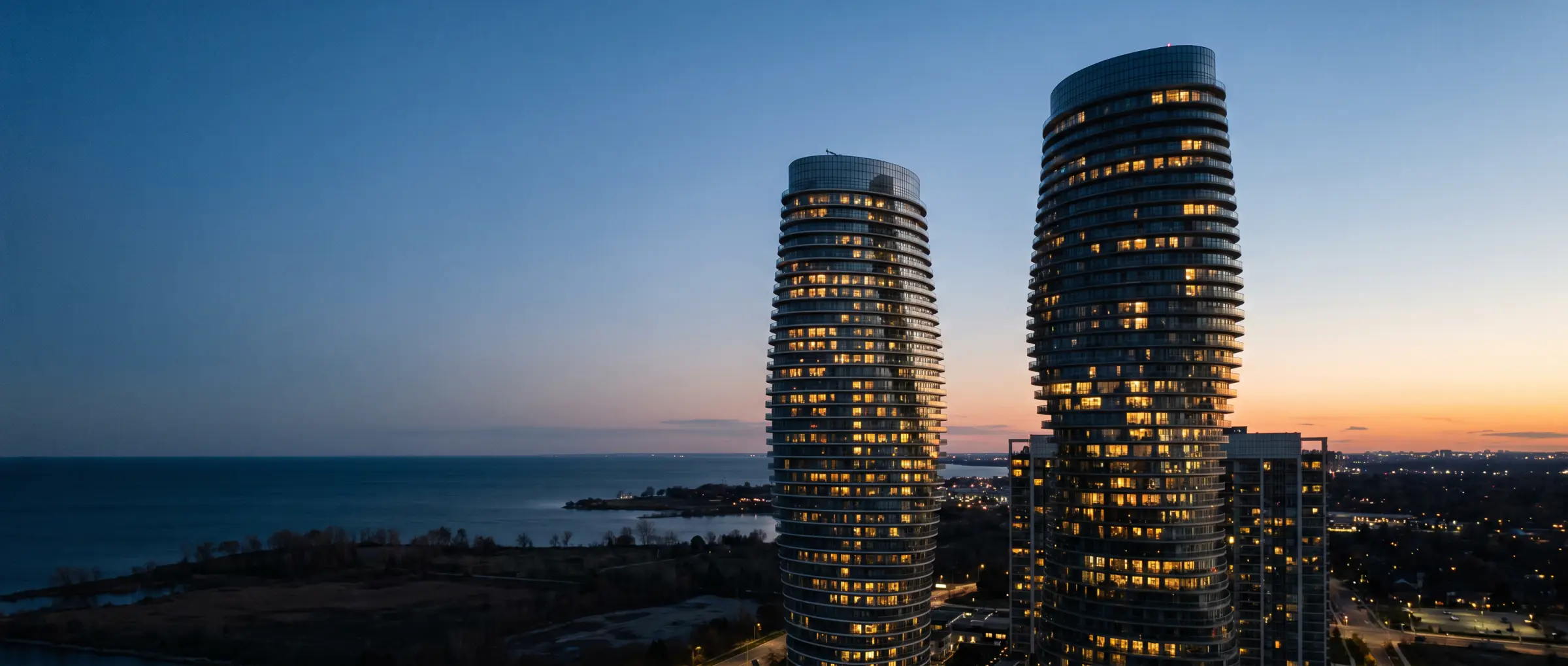 Christian-Owned Businesses in Mississauga, ON: the curved Absolute World towers at dusk