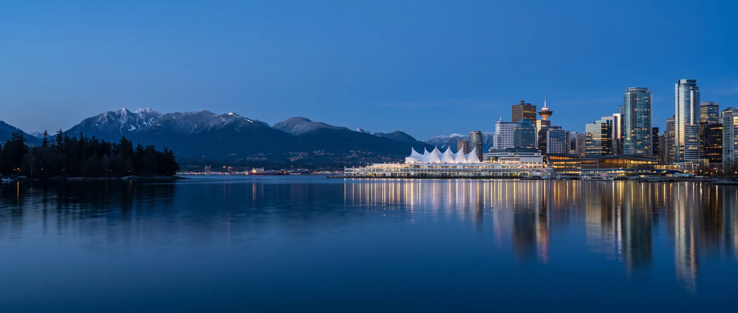 The Vancouver skyline across Coal Harbour below the North Shore mountains, British Columbia